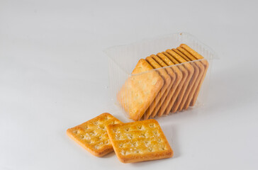 cracker biscuits with sugar in a transparent plastic container isolated on a white background