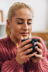 Blonde woman enjoying a hot drink