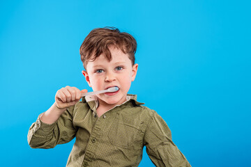 adorable little boy cleans his teeth