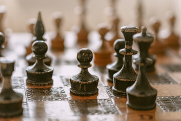 pawn and other figures on the vintage old chess board