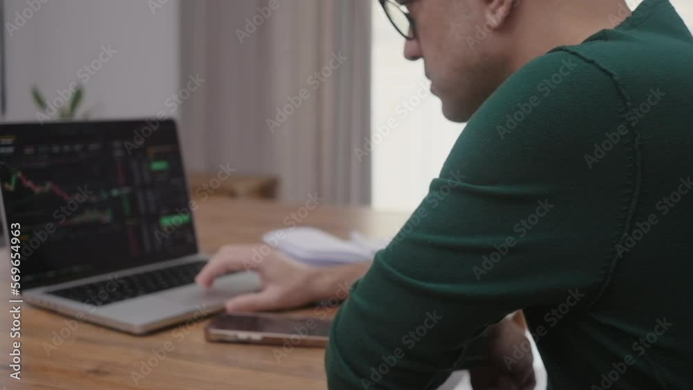 Poster online trader checking crypto currency graphs on laptop app screen, analist working at home with stock exchange market online