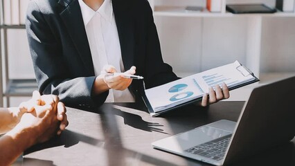 Financial analysts analyze business financial reports on a digital tablet planning investment project during a discussion at a meeting of corporate showing the results of their successful teamwork.