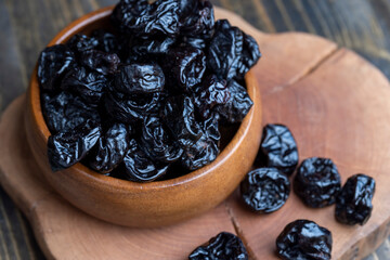 Black pile of prunes from a large number of ripe plums