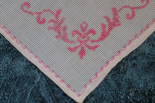 Cross-stitch with red floral pattern . Cross-stitch art. Handmade. etamine. Cross-stitch painting.