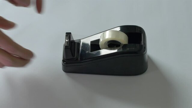 adhesive scotch tape dispenser, wrapping paper gift or office stationery concept, two closeups 