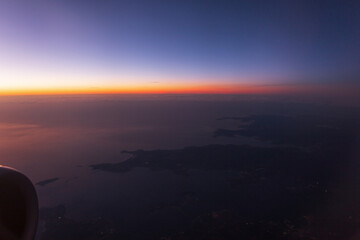 Beautiful night sky after sunset, photo from the window of an airplane. Amazing sunrise