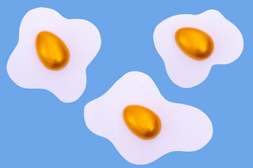 Creative layout made of scrambled eggs with decorated golden Easter eggs on a blue background.