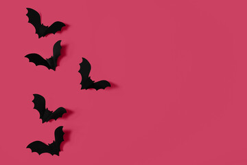 Cartoon halloween background black bats on orange backdrop. Bright holiday backdrop for your design in flat lay style with copy space.