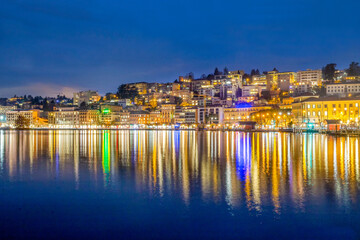 Fototapeta na wymiar Embankment of lake Lugano and town Lugano