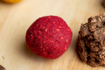 Red sweet candy in the shape of a ball on the table