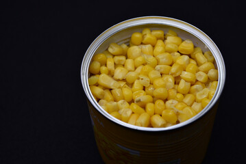 Fresh canned corn. Corn in a jar. Grains of yellow corn.