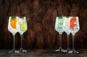Gin and tonic cocktails set. Alcoholic drinks with lime, lemon, grapefruit, cucumber, soda and...