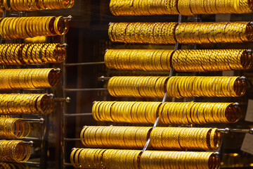 Close up of the jewelry gold necklaces ring, bracelets, show in  beauty retail store window display showcase background.