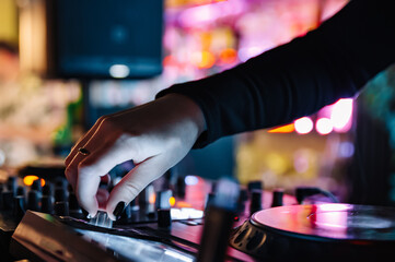 Fototapeta na wymiar DJ Hands creating and regulating music on dj console mixer in concert nightclub stage