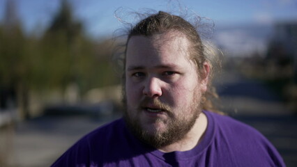 One angry young man arguing and pointing to camera POV. Portrait of a person speaking with upset emotion. Judgemental blaming expression