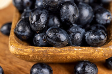 sweet ripe black grapes covered with drops of water