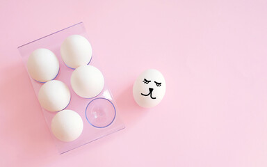creative concept photography. White eggs with face in box . Happy Easter holiday concept. minimalism