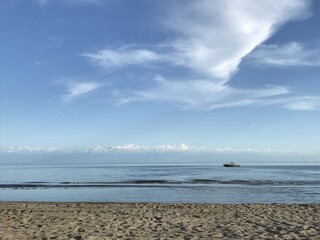 yacht at sea in the distance on a clear summer day