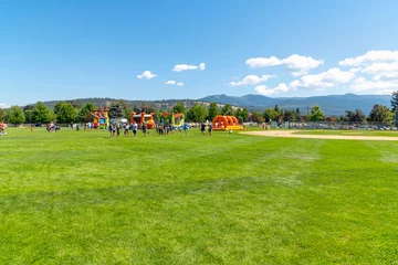 Foto auf Acrylglas Antireflex Families play at Pavilion Park during a summer festival and fair in the Spokane Washington suburb of Liberty Lake, Washington.  © Kirk Fisher