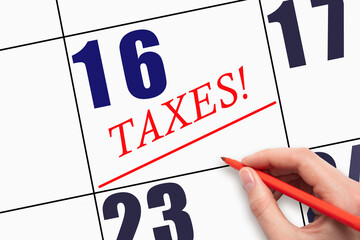 16th day of the month. Hand writing text TAXES and drawing a line on calendar date.
