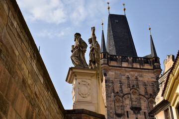 Fototapeta na wymiar Prague, Czech Republic. Charles Bridge with its statuettes. Lesser Town Bridge Tower and the tower of the Judith Bridge.