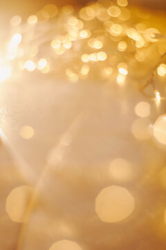 abstract shiny gold background. blured bokeh glowing golden background for design with copyspace. Shiny illumination lights