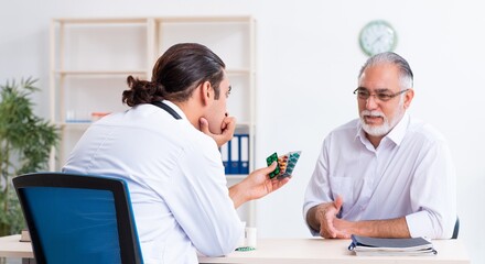 Old man visiting young male doctor