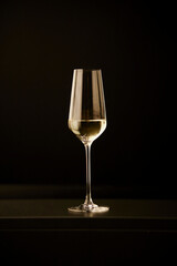 Glass of champagne isolated on black background. Champagne glass. Glass with champagne. Elegant glass of yellow champagne with bubbles on black background.