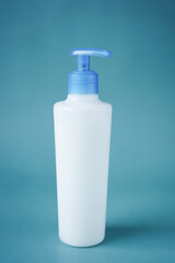 beauty cream in a plastic container on blue 