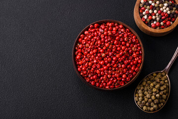 Composition, concept, consisting of several types of different colors of allspice in bowls and spoons