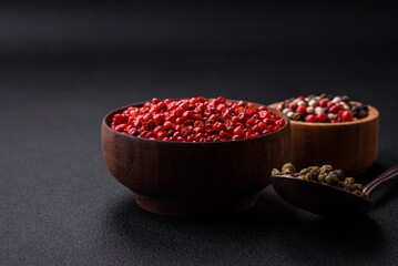 Composition, concept, consisting of several types of different colors of allspice in bowls and spoons