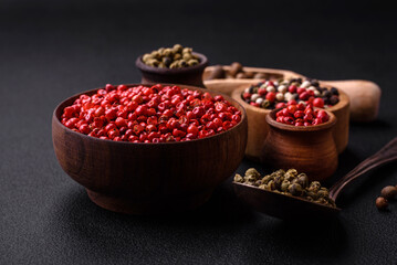 Composition, concept, consisting of several types of different colors of allspice in bowls and spoons