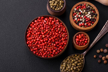 Composition, concept, consisting of several types of different colors of allspice in bowls and spoons