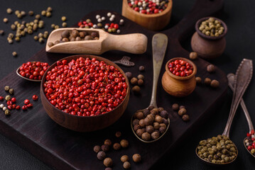 Composition, concept, consisting of several types of different colors of allspice in bowls and spoons