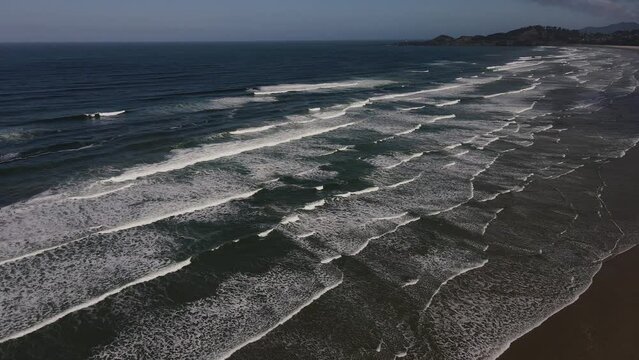 Slow Motion Drone Aerial Video Waves Pacific Coast Nye Beach Newport Oregon 11 Slow motion High angle static view of surf with Yaquina Head Lighthouse in background