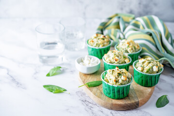 Spinach Feta cheese breakfast muffins with fresh spinach leaves