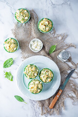 Spinach Feta cheese breakfast muffins with fresh spinach leaves