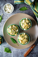Spinach Feta cheese breakfast muffins with fresh spinach leaves
