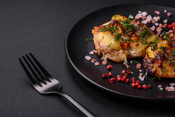 Meat baked in the oven with pineapple, tomatoes, cheese, spices and herbs