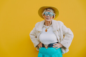 Happy grandmother posing on colored backgrounds