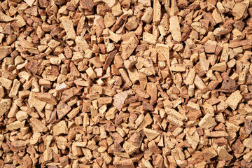 Background of granular sublimated powder for making a drink, coffee. Top view. Space for lettering and design.