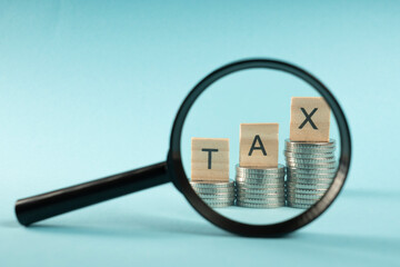 Wooden cubes labeled "TAX" concept, business and success in finance. The economic growth of finance. Money work investment concept