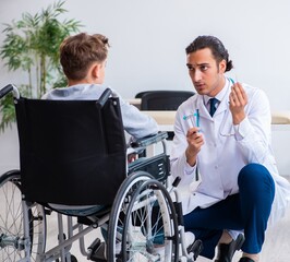Young male doctor pediatrist and boy in wheel-chair