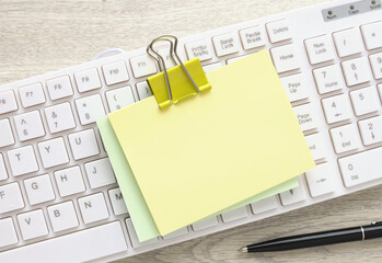 One blank note paper, on a white keyboard