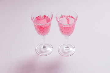 Two pink cocktails for Valentine's day celebration. Love and anniversary setting with hearts. Romantic concept