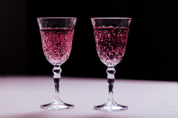 Two pink cocktails for Valentine's day celebration. Love and anniversary setting with hearts. Romantic concept