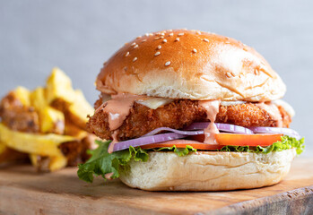 Delicious fried chicken crispy sandwich with spicy buffalo sauce, served with French fries.