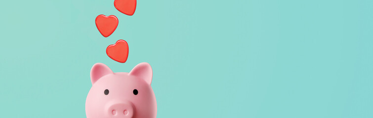pink piggy bank with falling hearts on a blue background - concept of protection and preservation of love - copy space