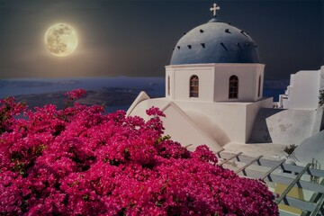 Moon ovewr island Santorini in Greece