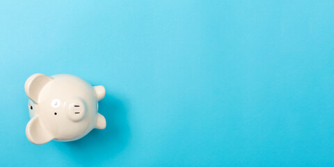 A piggy bank saving and investment theme on a blue paper background
